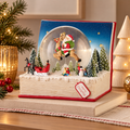 Palla di Neve Natalizia con Babbo Natale sulla Renna e Paesaggio Innevato a Forma di Libro – Collezione I Sogni dei Piccoli 18x16,5x17 cm